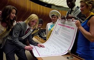 Niki Lanik signing a petition for human rights at the Seventh Annual International Human Rights Summit in Geneva.